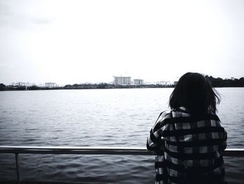 Rear view of woman looking at river