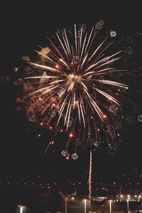 Low angle view of firework display at night