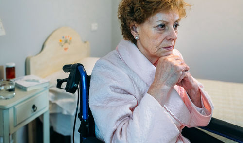 Close-up of senior female patient sitting on wheelchair in hospital