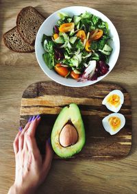 High angle view of person holding breakfast on table