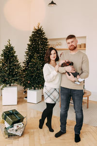 A family with a small child celebrate the new year at the christmas holidays on the weekend at home