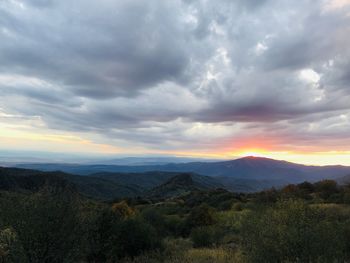 Scenic view of landscape against dramatic sky