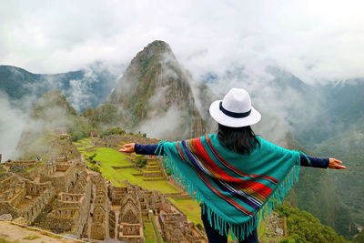 Rear view of woman with hat on mountain