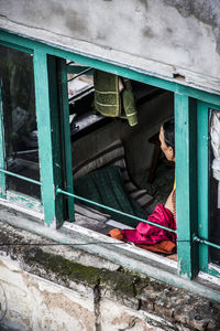 Woman lying on window