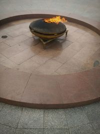 High angle view of burning candles on tiled floor