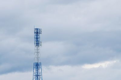 Low angle view of communications tower against sky