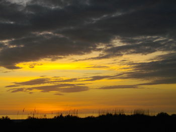 Silhouette landscape against scenic sky