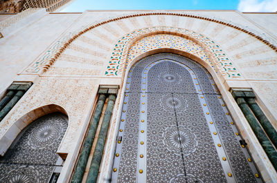 Low angle view of mosque hassan ii against sky in city