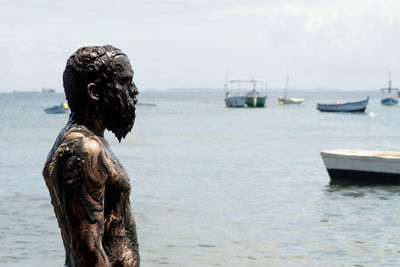 Rear view of man standing in boat