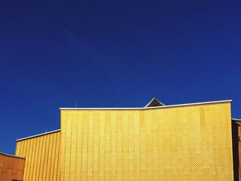 Low angle view of building against blue sky