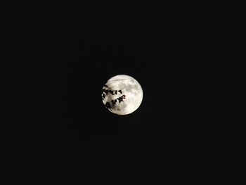 Low angle view of moon against black sky