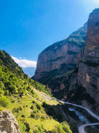 Scenic view of mountains against blue sky