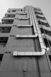 Ventilation duct on the side of the building in the city. black and white.