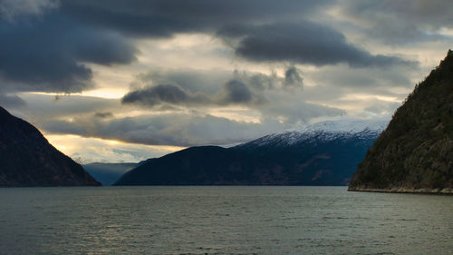 Scenic view of sea and mountains against sky