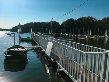 Boats moored on lake against sky