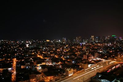 Aerial view of city lit up at night