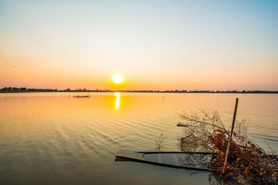 Scenic view of lake against sky during sunset