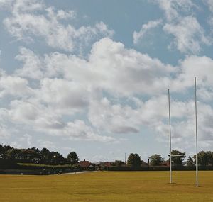 Scenic view of field against cloudy sky