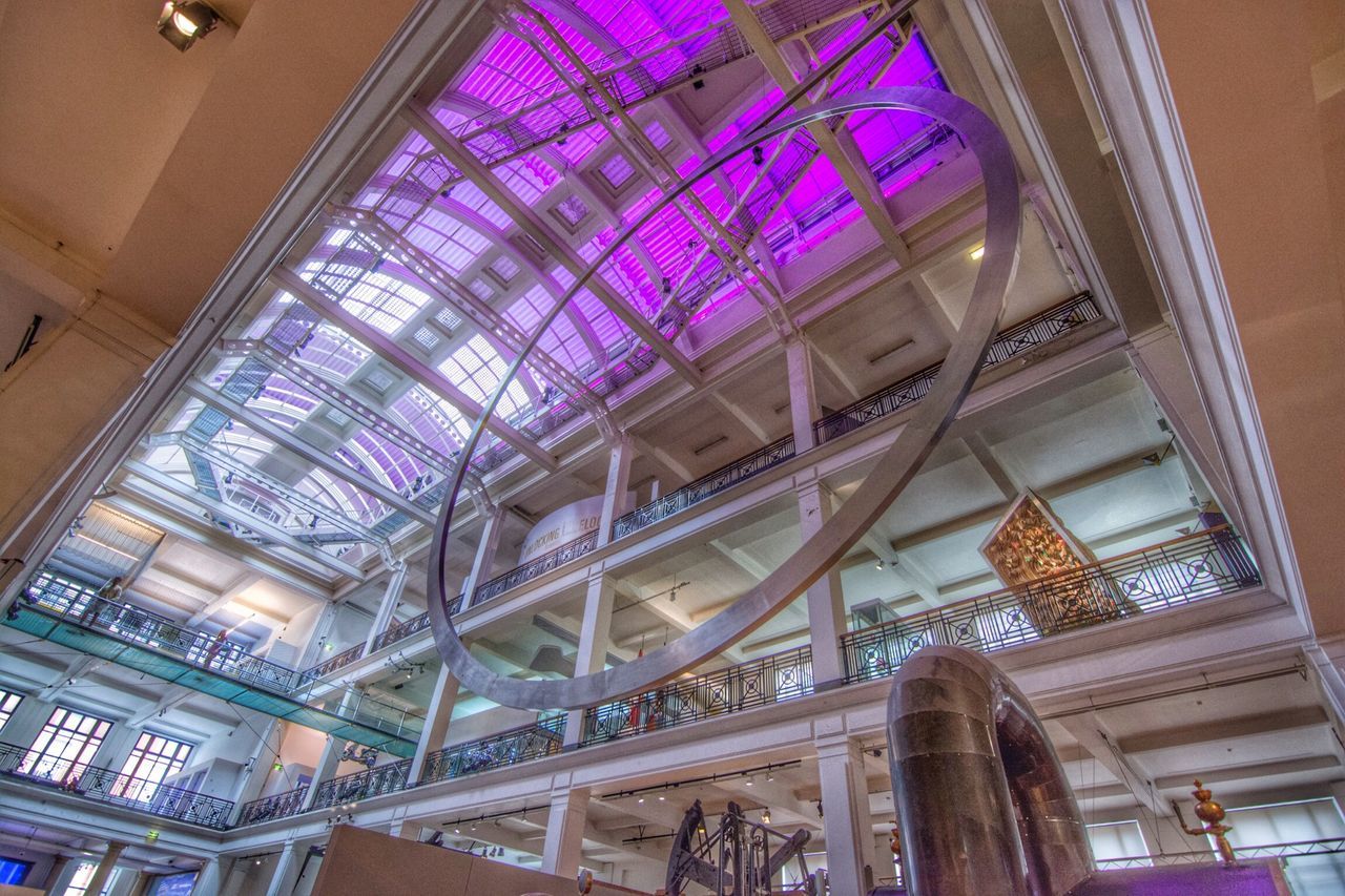 indoors, architecture, built structure, low angle view, ceiling, window, illuminated, glass - material, skylight, building, building exterior, interior, architectural feature, modern, no people, pattern, lighting equipment, stained glass, shopping mall, transparent