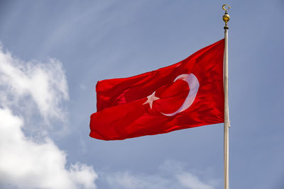 Low angle view of flag against sky