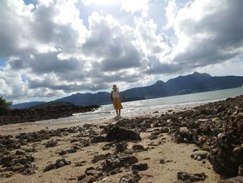 Man standing on beach against sky