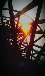 Low angle view of silhouette built structure against sky