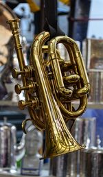 Close-up of trumpet hanging at store