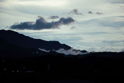 Scenic view of silhouette mountains against sky at sunset