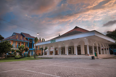 Exterior of houses against sky during sunset