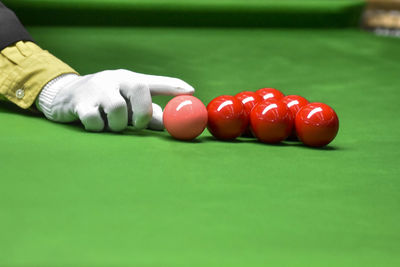 Cropped hand of person playing pool