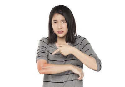 Portrait of a young woman against white background