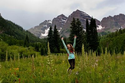 Full length of man standing on mountain in forest