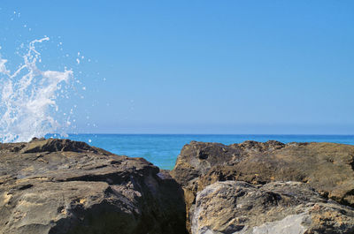 Scenic view of sea against clear blue sky