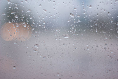 Full frame shot of wet glass window during rainy season