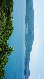 High angle view of sea and mountains against sky