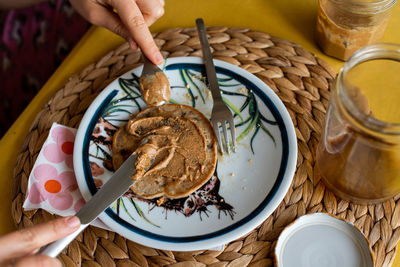 Midsection of woman holding ice cream in plate