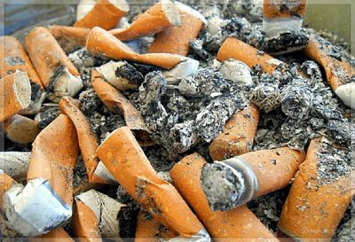 Close-up of cigarette butts and ash