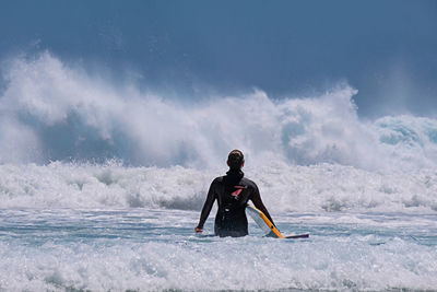 Full length of man in sea against sky