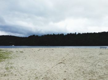 Scenic view of lake against cloudy sky