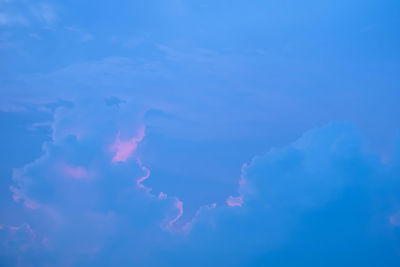 Low angle view of lightning against blue sky