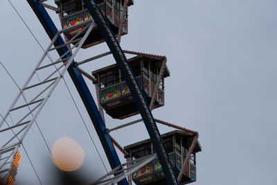 Low angle view of ferris wheel against building
