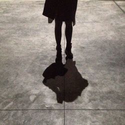 Low section of woman standing on tiled floor