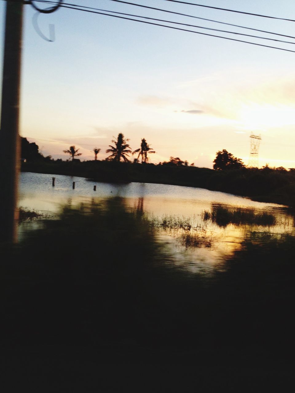 sunset, silhouette, water, sky, scenics, tranquil scene, orange color, tranquility, beauty in nature, reflection, tree, nature, lake, idyllic, cloud - sky, waterfront, river, dusk, sea, outdoors