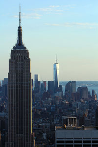 Empire state building with cityscape against sky