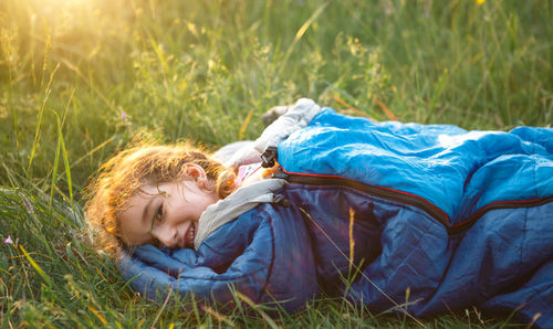 High angle view of woman sitting on grassy field