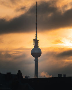 Silhouette of building against cloudy sky during sunset