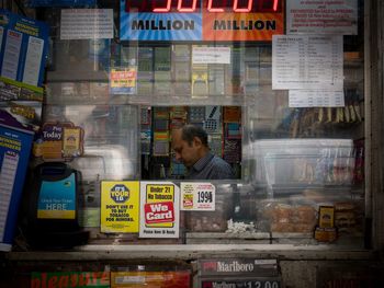 Reflection of man in store