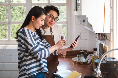 Young woman using mobile phone in office