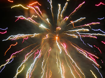 Low angle view of firework display at night