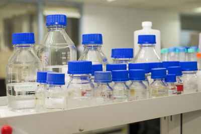 Close-up bottles on rack in laboratory